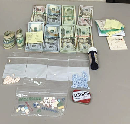 Police seize cash, pills and suspected drug transaction ledger