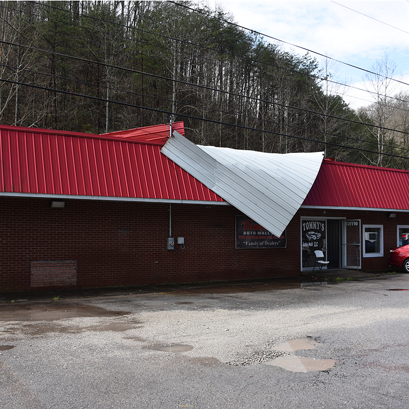 Wind damages Maynard car lot office