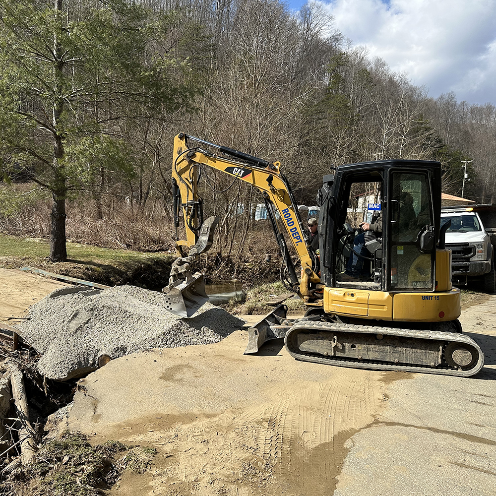 Flood destroys bridge, traps families on Mac Pinson Drive